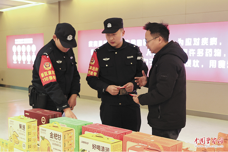 江西省共青城市公安局新区派出所民警辅警查看企业展示厅安防情况