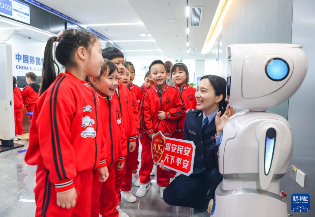 在江苏省扬州市公安局江都分局出入境管理大队通过与机器人对话给小朋友们了解出入境安全知识